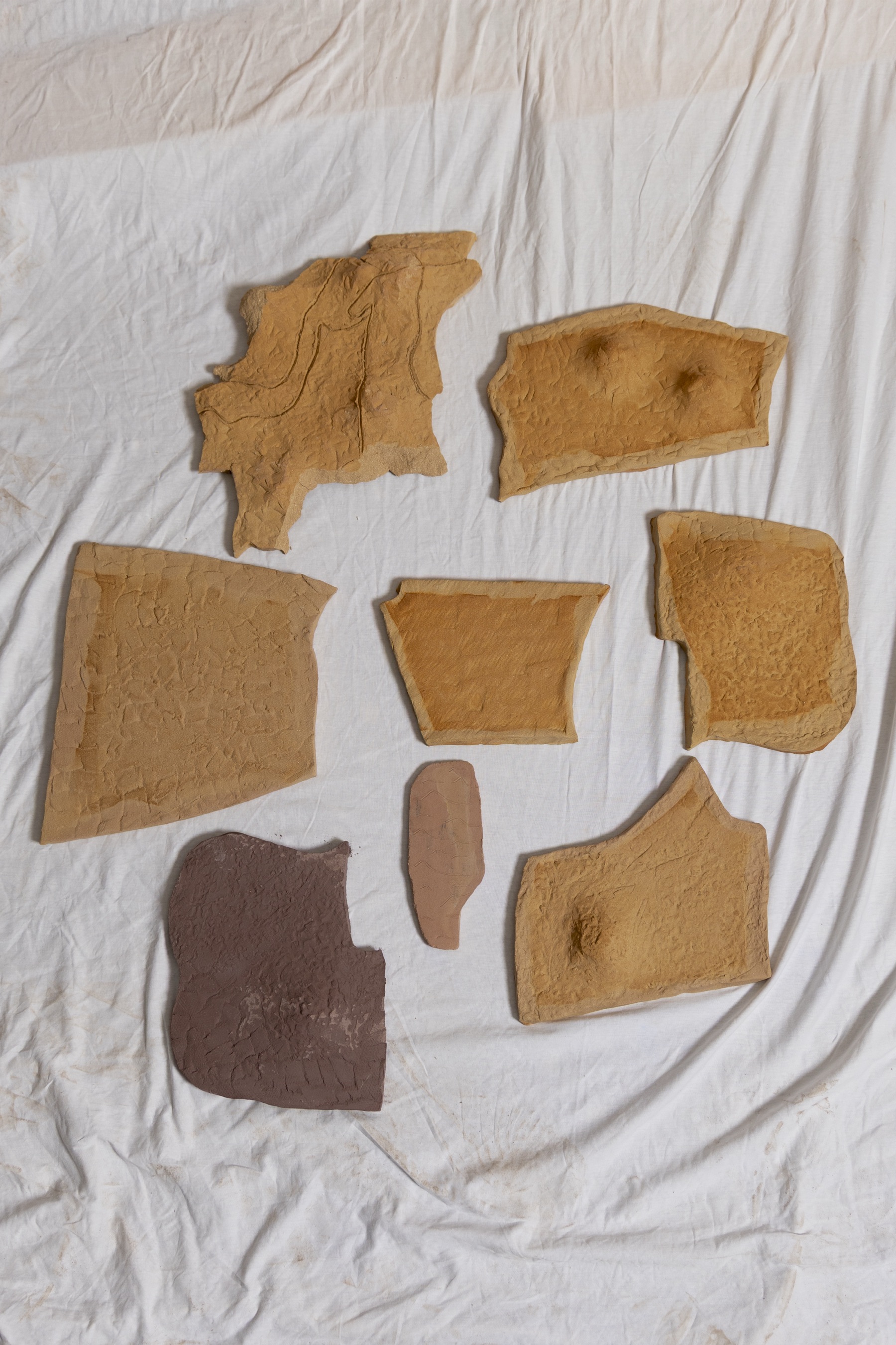 Ceramic fragments laid on white cloth